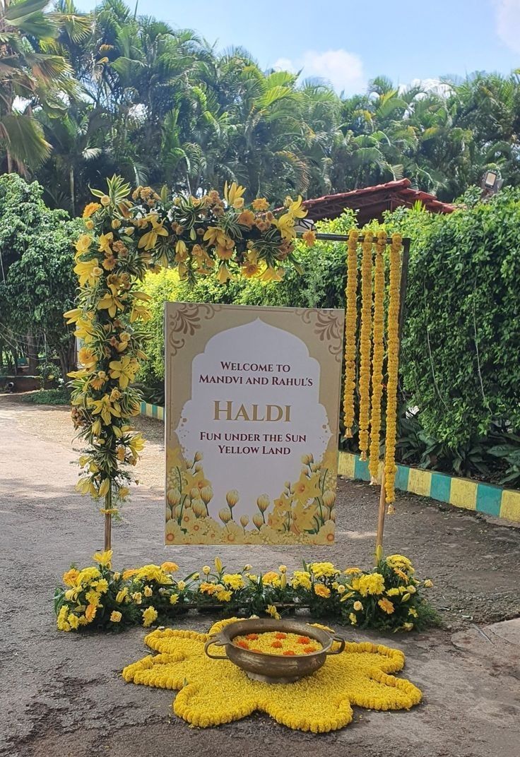 Yellow Haldi Welcome Sign Decor with Marigold Garlands and Lily Floral Frame