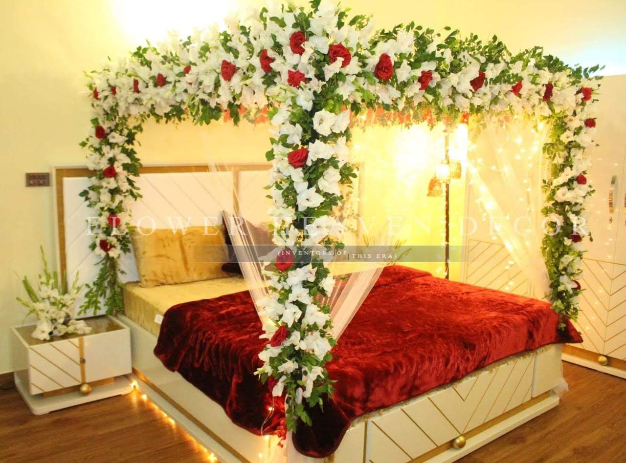 Elegant Red & White Floral Bridal Bed Decor with Fairy Lights