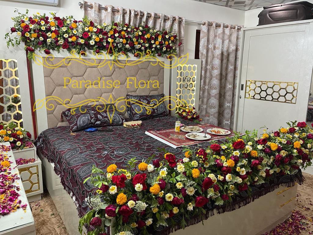 Elegant Bridal Bed Floral Decoration with Red Roses and Marigolds
