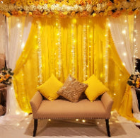Elegant Yellow & White Floral Backdrop with Fairy Lights & Sofa