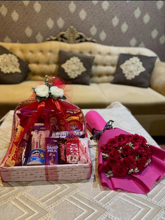 Chocolate and snacks basket with flower bouquet