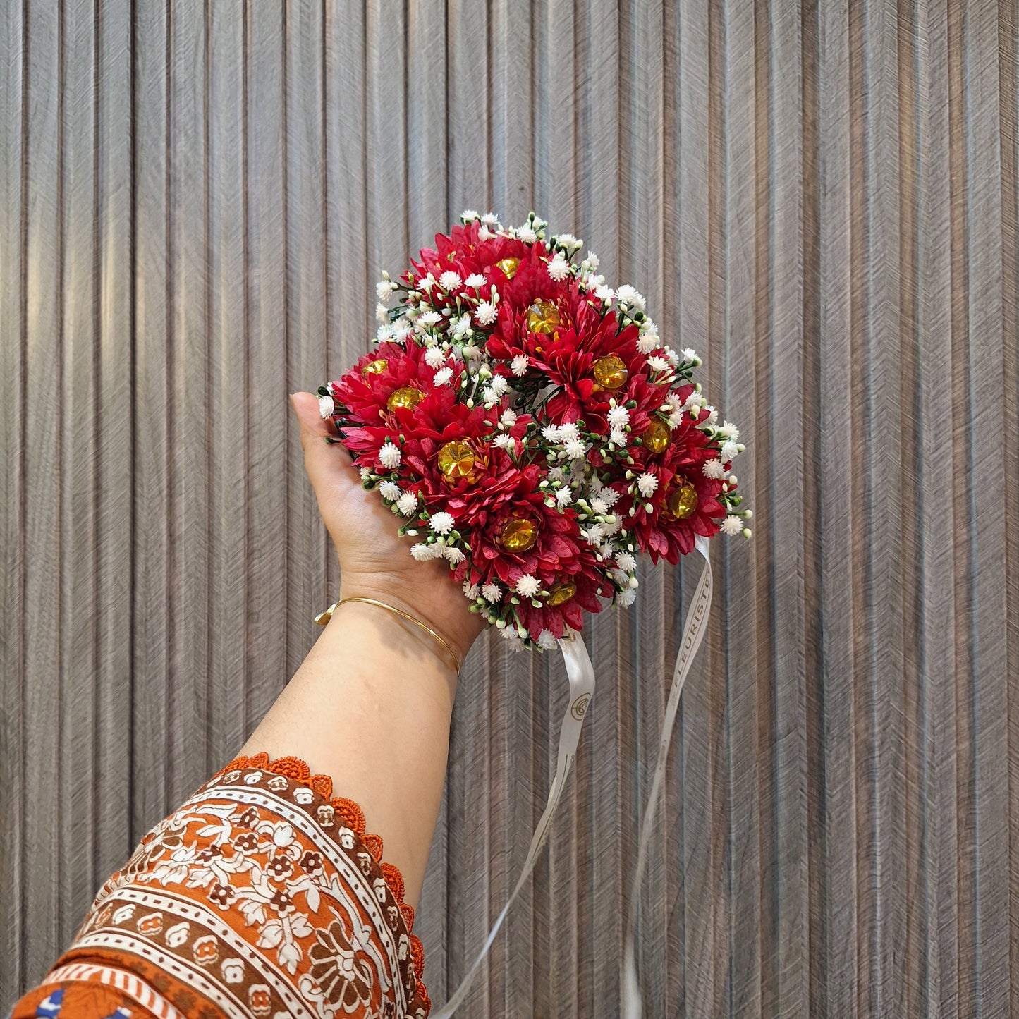 Red Floral Gaira with White Baby’s Breath and Golden Accents